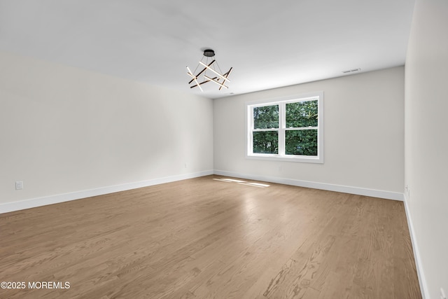 21 Pension Hill Rd, Manalapan, NJ 07726 - empty room featuring a chandelier and wood finished floors