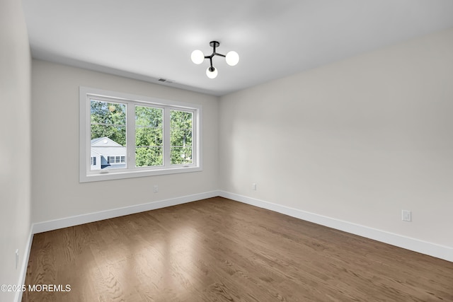 21 Pension Hill Rd, Manalapan, NJ 07726 - empty room featuring dark wood finished floors and a chandelier