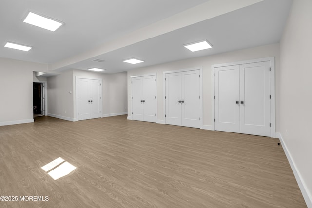 21 Pension Hill Rd, Manalapan, NJ 07726 - below grade area with light wood-style flooring