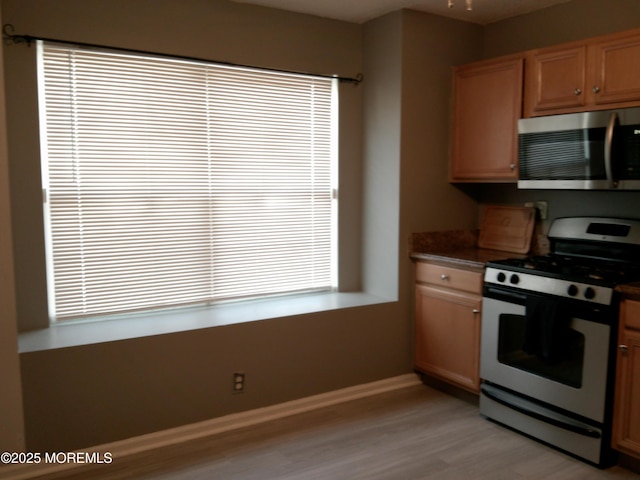 25 Watson Ct, Howell, NJ 07731 - kitchen with appliances with stainless steel finishes, light wood finished floors, dark countertops, and brown cabinetry