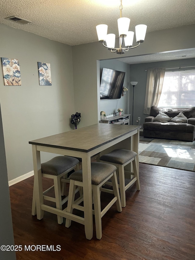 25 Watson Ct, Howell, NJ 07731 - dining space with a chandelier, dark wood-type flooring, and a textured ceiling