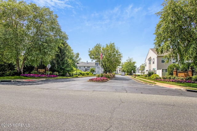 141 Setter Pl, Freehold, NJ 07728 - view of asphalt road featuring curbs, sidewalks, a residential view, and traffic signs