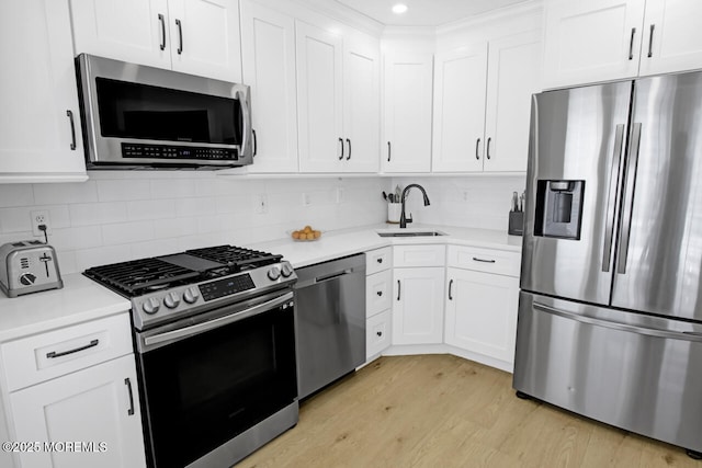 141 Setter Pl, Freehold, NJ 07728 - kitchen featuring stainless steel appliances, light countertops, light wood-style flooring, white cabinets, and recessed lighting