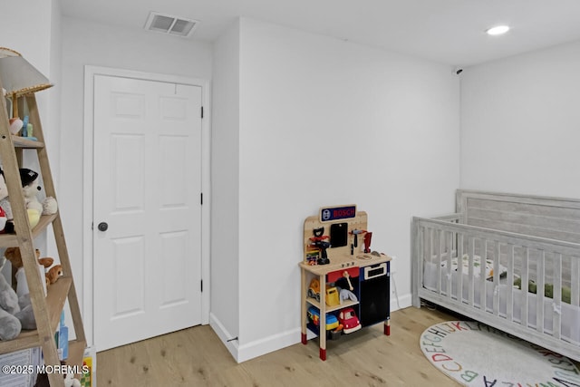 141 Setter Pl, Freehold, NJ 07728 - bedroom with light wood finished floors, a crib, and recessed lighting
