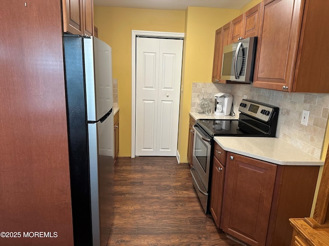 9 Maine Ct Unit 741, Matawan, NJ 07747 - kitchen featuring appliances with stainless steel finishes, dark wood-type flooring, light countertops, tasteful backsplash, and brown cabinets