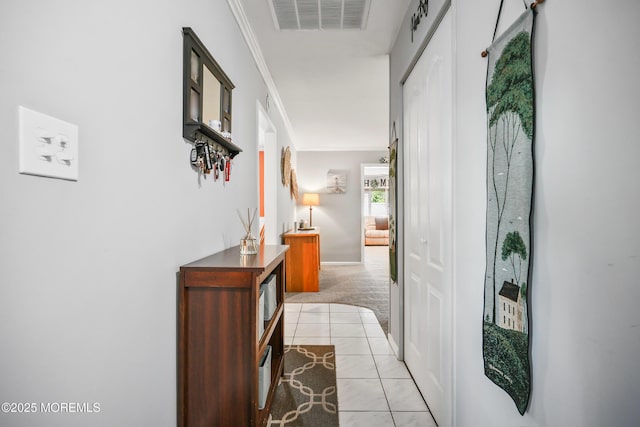 149 Idlewild Ln, Aberdeen, NJ 07747 - hallway featuring crown molding, light tile patterned floors, and light colored carpet