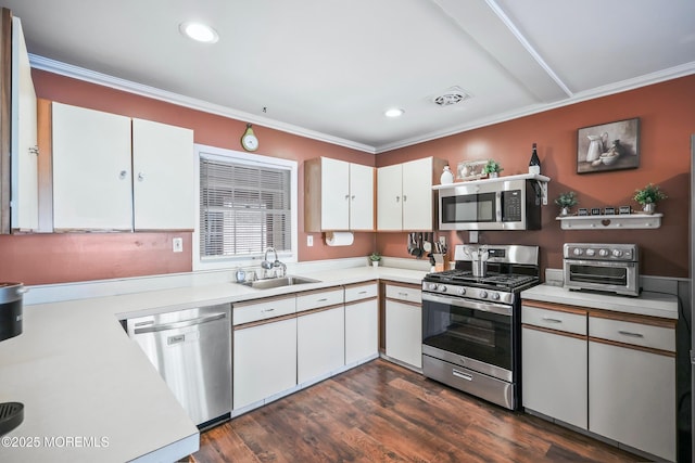 149 Idlewild Ln, Aberdeen, NJ 07747 - kitchen with appliances with stainless steel finishes, light countertops, crown molding, white cabinetry, and dark wood-style flooring
