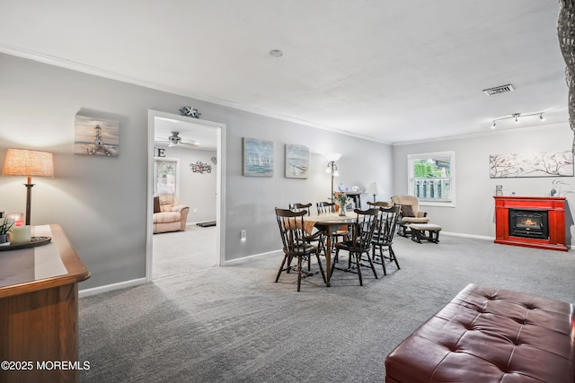 149 Idlewild Ln, Aberdeen, NJ 07747 - dining area with ornamental molding, carpet flooring, and a lit fireplace