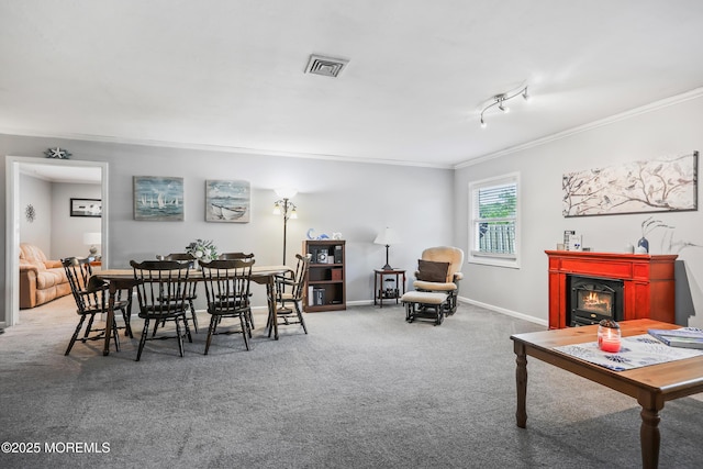 149 Idlewild Ln, Aberdeen, NJ 07747 - carpeted dining area featuring ornamental molding, a warm lit fireplace, and track lighting