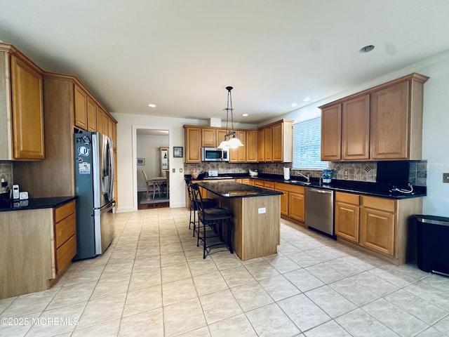1642 Mink Ct, Toms River, NJ 08755 - kitchen with stainless steel appliances, tasteful backsplash, light tile patterned floors, a kitchen breakfast bar, and recessed lighting