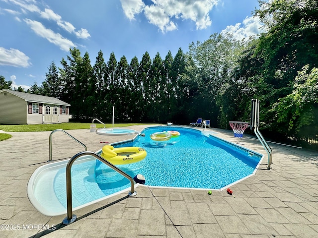 1642 Mink Ct, Toms River, NJ 08755 - outdoor pool featuring a patio area, an outbuilding, a storage structure, and view of wooded area