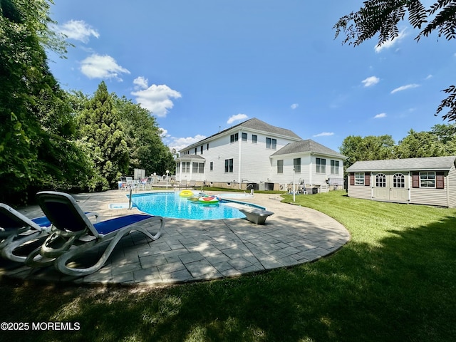 1642 Mink Ct, Toms River, NJ 08755 - view of swimming pool with a diving board, an outbuilding, a lawn, and a patio area