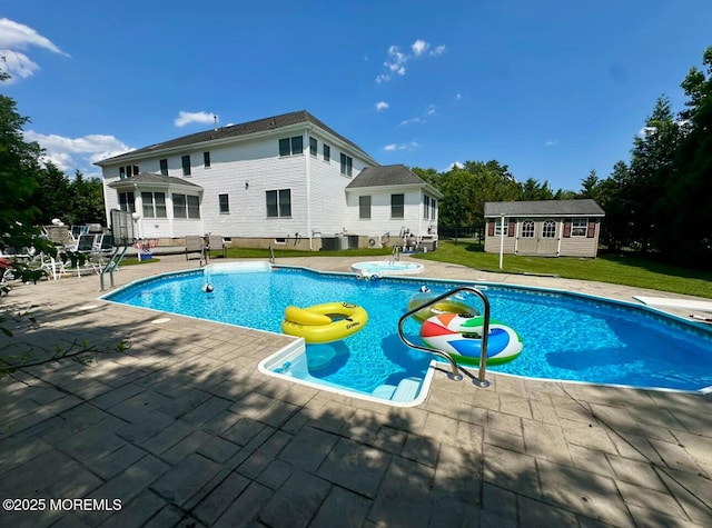 1642 Mink Ct, Toms River, NJ 08755 - view of swimming pool featuring an outdoor structure, a lawn, a patio area, and a hot tub