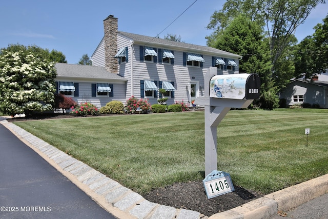 1405 Rockafeller Dr, Wall, NJ 07719 - colonial home featuring a chimney and a front lawn