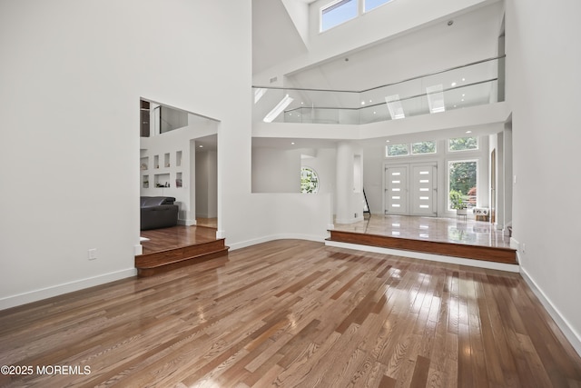 42 Nikki Ct, Morganville, NJ 07751 - unfurnished living room featuring a high ceiling and hardwood / wood-style flooring