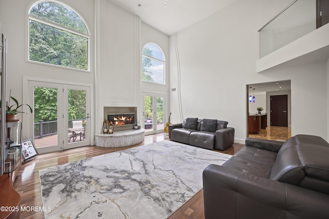 42 Nikki Ct, Morganville, NJ 07751 - living room with high vaulted ceiling, a fireplace, and wood finished floors