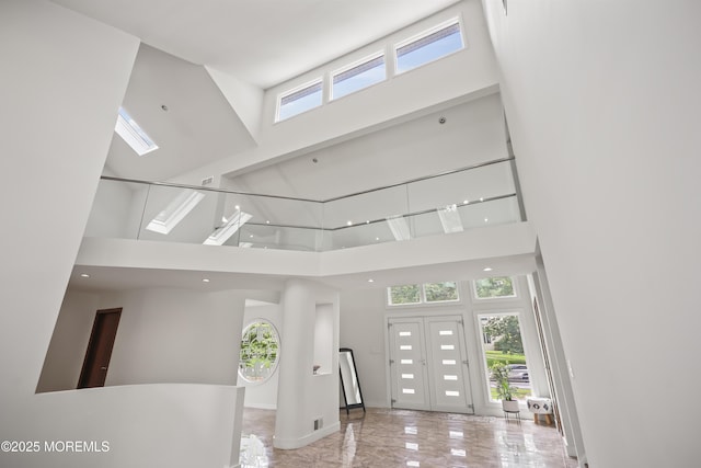 42 Nikki Ct, Morganville, NJ 07751 - foyer entrance with a high ceiling, marble tiled flooring, and a skylight