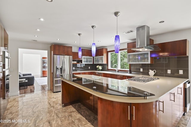 42 Nikki Ct, Morganville, NJ 07751 - kitchen with island range hood, appliances with stainless steel finishes, modern cabinets, tasteful backsplash, and decorative light fixtures