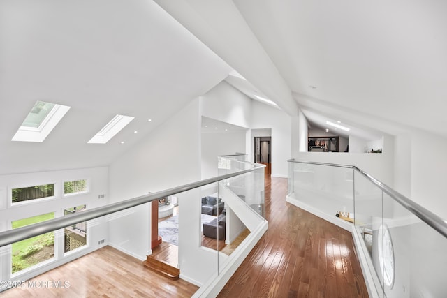42 Nikki Ct, Morganville, NJ 07751 - hall with an upstairs landing, a skylight, wood finished floors, high vaulted ceiling, and recessed lighting