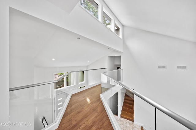 42 Nikki Ct, Morganville, NJ 07751 - corridor with a high ceiling, healthy amount of natural light, wood finished floors, and an upstairs landing