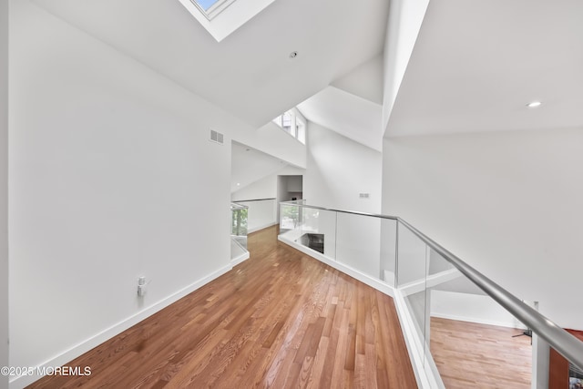 42 Nikki Ct, Morganville, NJ 07751 - hall with a skylight, an upstairs landing, a high ceiling, wood finished floors, and recessed lighting