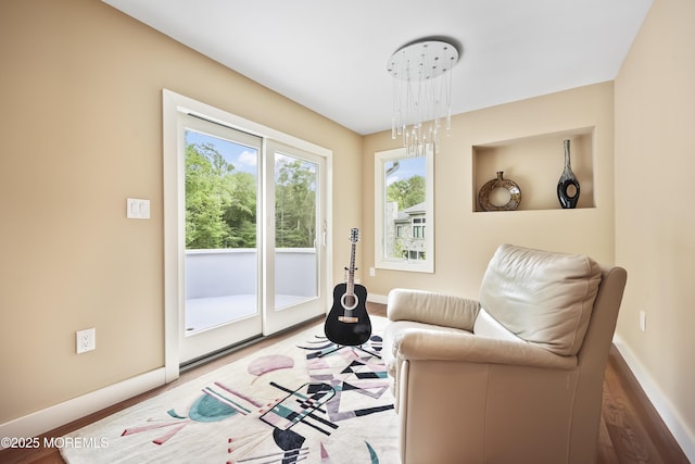 42 Nikki Ct, Morganville, NJ 07751 - sitting room with wood finished floors and a chandelier
