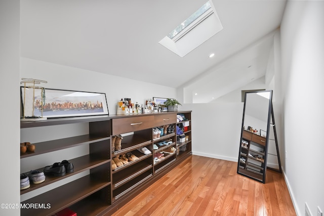 42 Nikki Ct, Morganville, NJ 07751 - bar area featuring a skylight, lofted ceiling, and wood finished floors