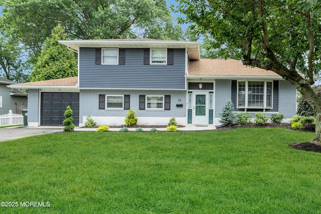 24 Willow Brook Rd, Freehold, NJ 07728 - split level home with a garage, brick siding, and concrete driveway