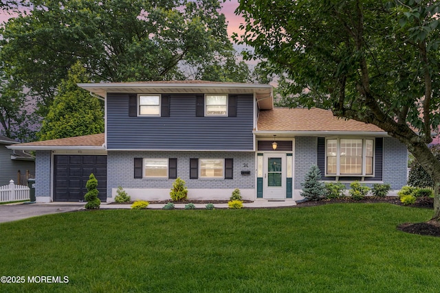 24 Willow Brook Rd, Freehold, NJ 07728 - split level home featuring an attached garage, brick siding, and concrete driveway