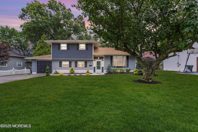 24 Willow Brook Rd, Freehold, NJ 07728 - split level home with concrete driveway, an attached garage, and brick siding
