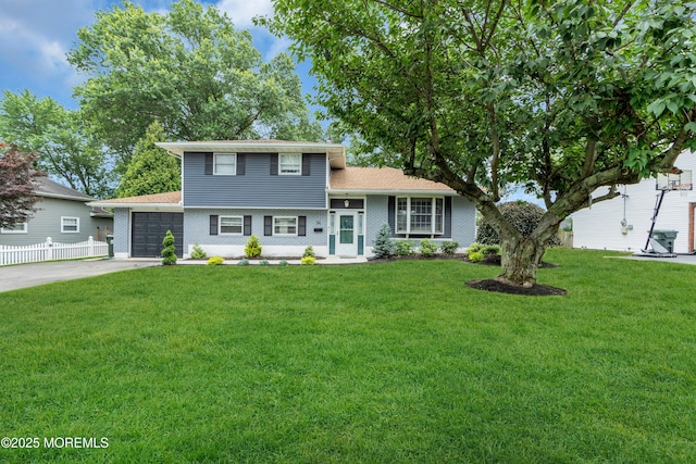 24 Willow Brook Rd, Freehold, NJ 07728 - tri-level home featuring an attached garage, driveway, and brick siding
