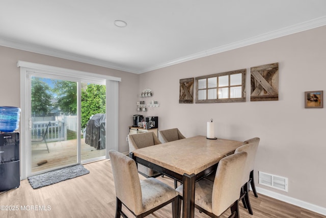 24 Willow Brook Rd, Freehold, NJ 07728 - dining room featuring wood finished floors and ornamental molding