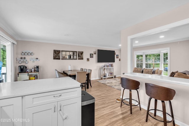 24 Willow Brook Rd, Freehold, NJ 07728 - kitchen featuring open floor plan, white cabinets, light wood-style floors, a kitchen bar, and recessed lighting