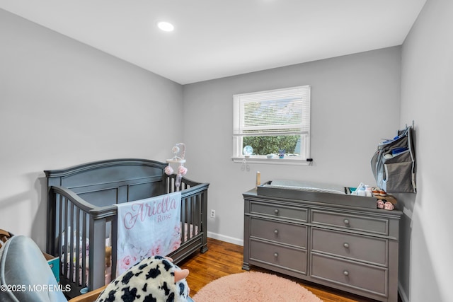 24 Willow Brook Rd, Freehold, NJ 07728 - bedroom featuring wood finished floors, recessed lighting, and a crib