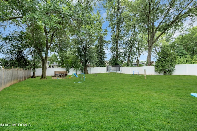 24 Willow Brook Rd, Freehold, NJ 07728 - fenced backyard featuring a trampoline