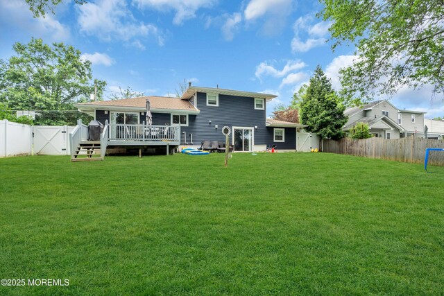 24 Willow Brook Rd, Freehold, NJ 07728 - rear view of house with a gate, a deck, and a fenced backyard