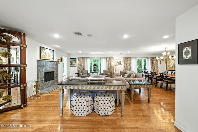 7 Stony Ridge Dr, Hillsdale, NJ 07642 - living room with light wood-style flooring, a tile fireplace, a chandelier, and recessed lighting