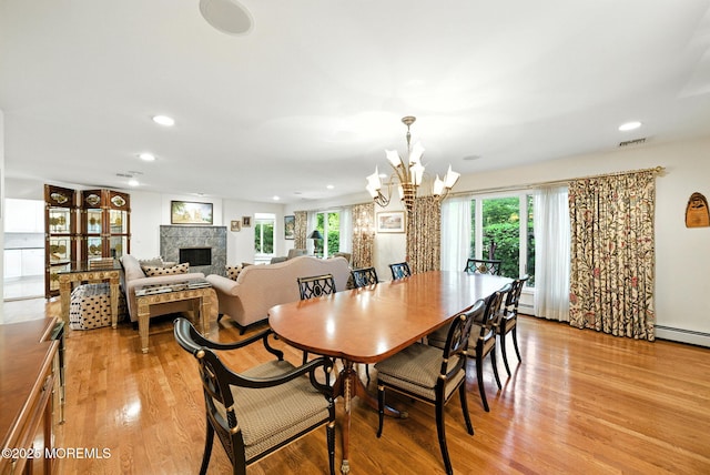 7 Stony Ridge Dr, Hillsdale, NJ 07642 - dining room with a fireplace, a chandelier, healthy amount of natural light, light wood-style floors, and recessed lighting