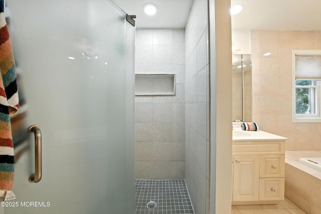 7 Stony Ridge Dr, Hillsdale, NJ 07642 - bathroom featuring tile patterned floors, vanity, a tile shower, a bath, and tile walls