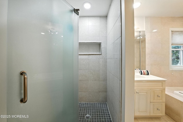 7 Stony Ridge Dr, Hillsdale, NJ 07642 - bathroom featuring tile patterned floors, tile walls, a stall shower, vanity, and a garden tub
