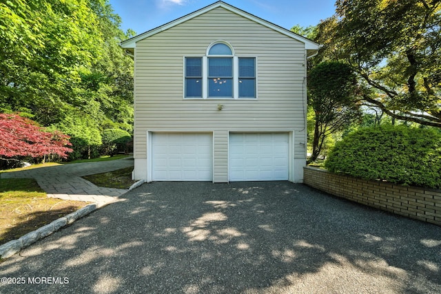 7 Stony Ridge Dr, Hillsdale, NJ 07642 - view of side of home featuring asphalt driveway and a garage