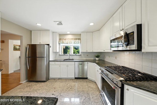 7 Stony Ridge Dr, Hillsdale, NJ 07642 - kitchen with stainless steel appliances, dark countertops, white cabinetry, decorative backsplash, and recessed lighting