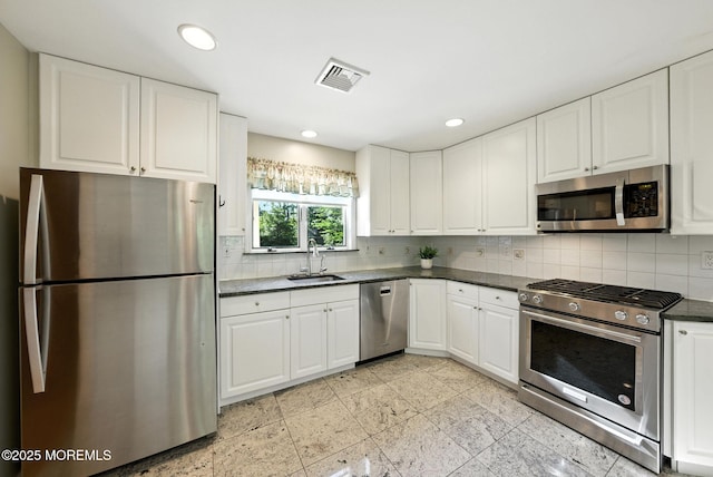 7 Stony Ridge Dr, Hillsdale, NJ 07642 - kitchen featuring appliances with stainless steel finishes, dark countertops, backsplash, recessed lighting, and white cabinets