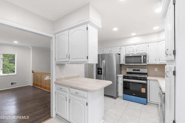 424 River Ter, Toms River, NJ 08755 - kitchen with appliances with stainless steel finishes, a peninsula, light countertops, white cabinets, and recessed lighting