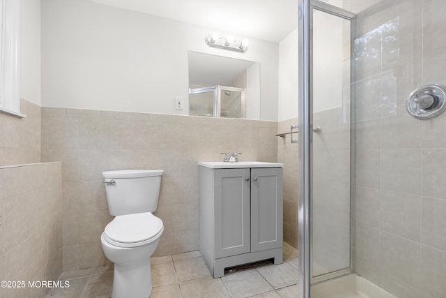 424 River Ter, Toms River, NJ 08755 - bathroom with tile walls, a stall shower, tile patterned flooring, vanity, and a wainscoted wall