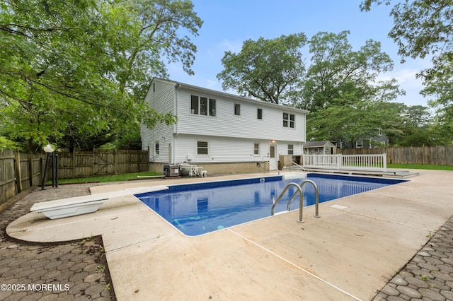 424 River Ter, Toms River, NJ 08755 - view of pool with a diving board, a fenced backyard, a deck, and a patio