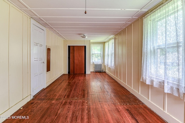 1416 Garven Ave, Ocean Twp, NJ 07712 - spare room with radiator, wood finished floors, and a decorative wall