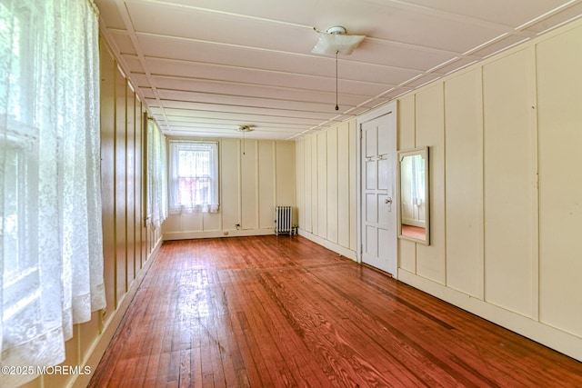 1416 Garven Ave, Ocean Twp, NJ 07712 - spare room with radiator heating unit, hardwood / wood-style flooring, and a decorative wall