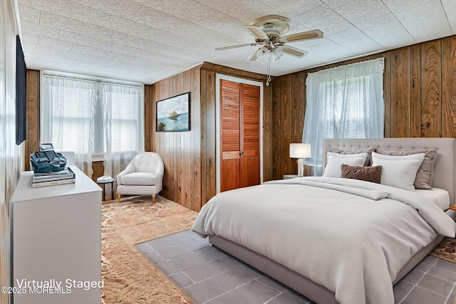 1416 Garven Ave, Ocean Twp, NJ 07712 - carpeted bedroom featuring wood walls, a closet, and a ceiling fan