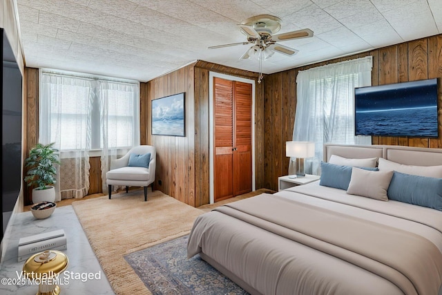 1416 Garven Ave, Ocean Twp, NJ 07712 - bedroom with wooden walls, a ceiling fan, and a closet